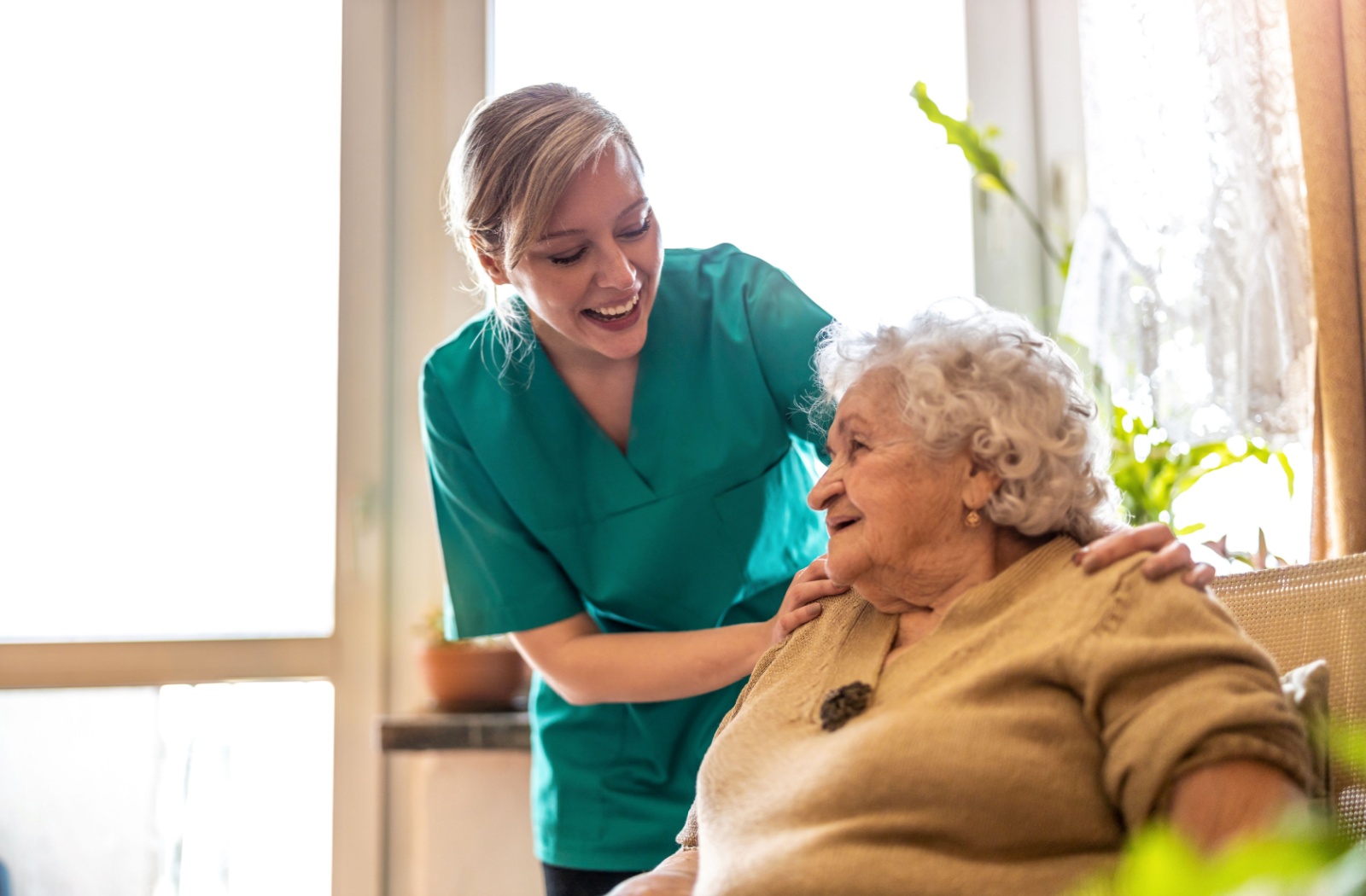 Caregiver providing personalized attention and support to an elderly woman in a memory care setting, fostering a compassionate and comforting environment.