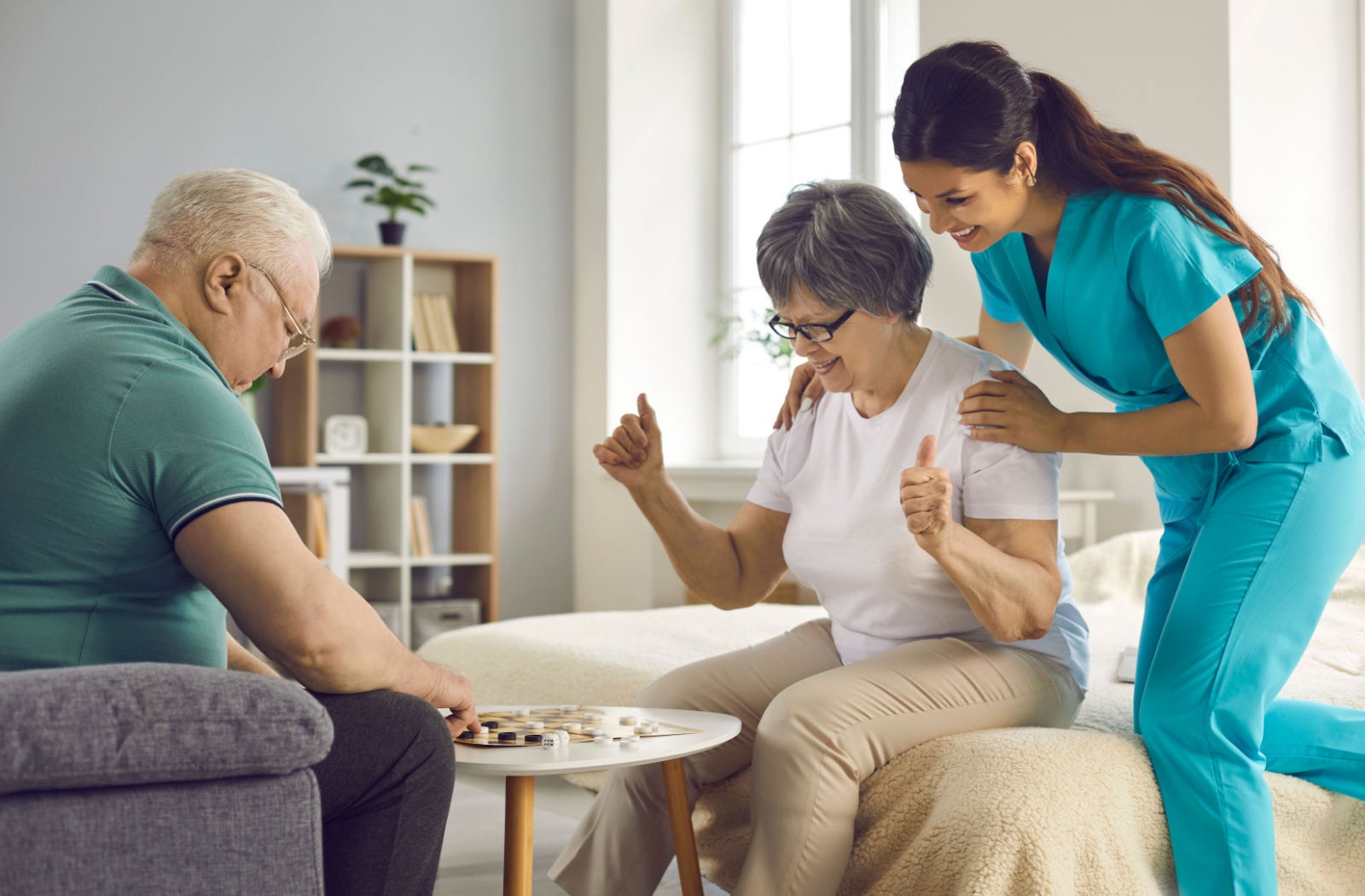 Memory care residents enjoying a game of checkers with a caregiving staff.